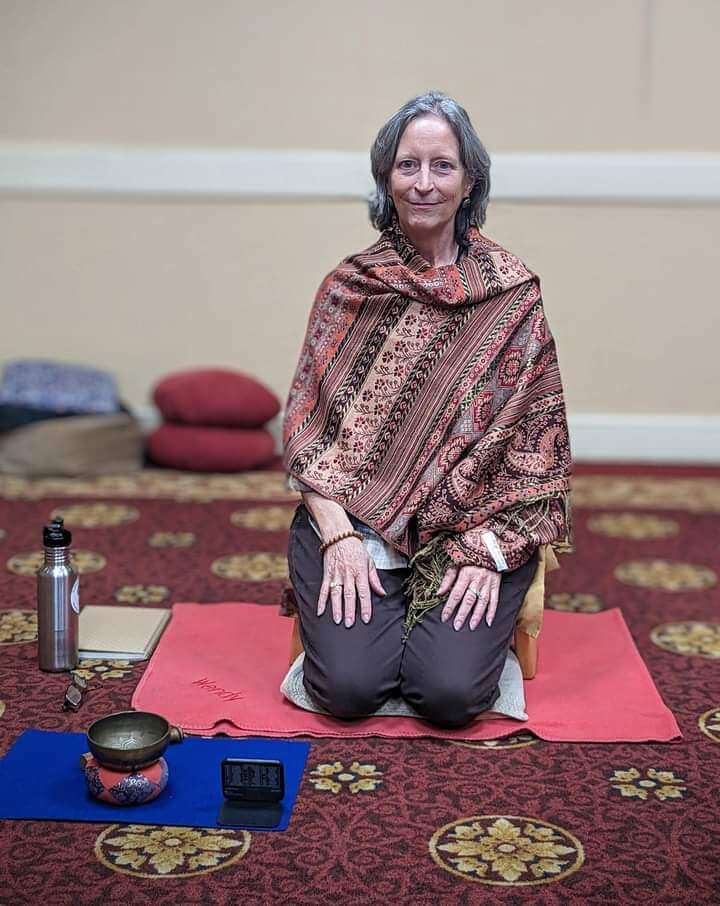 Wendy Krom kneeling in preparation for mindfulness meditation